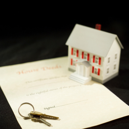 77006495-model-house-next-to-paperwork-and-keys-gettyimages